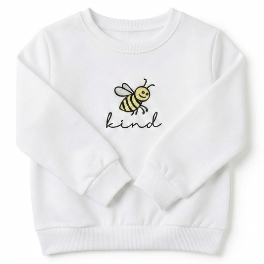 A white sweatshirt with a bee and the word "kind" embroidered on the front 