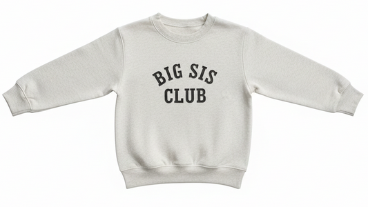 A white, heathered sweatshirt with the words "BIG SIS CLUB" embroidered on the front in black thread